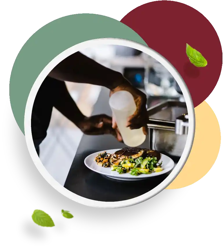 A person pouring food into a plate on top of a table.